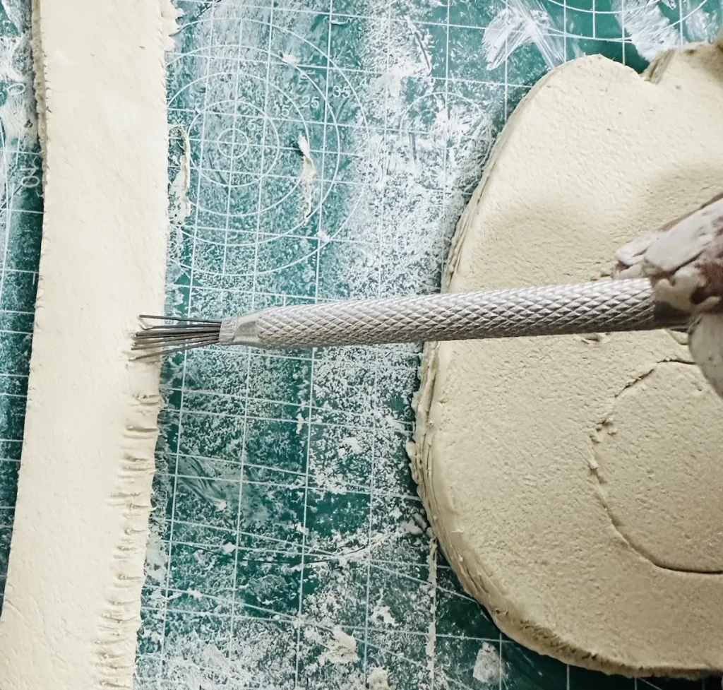 scoring the tray rim before attach