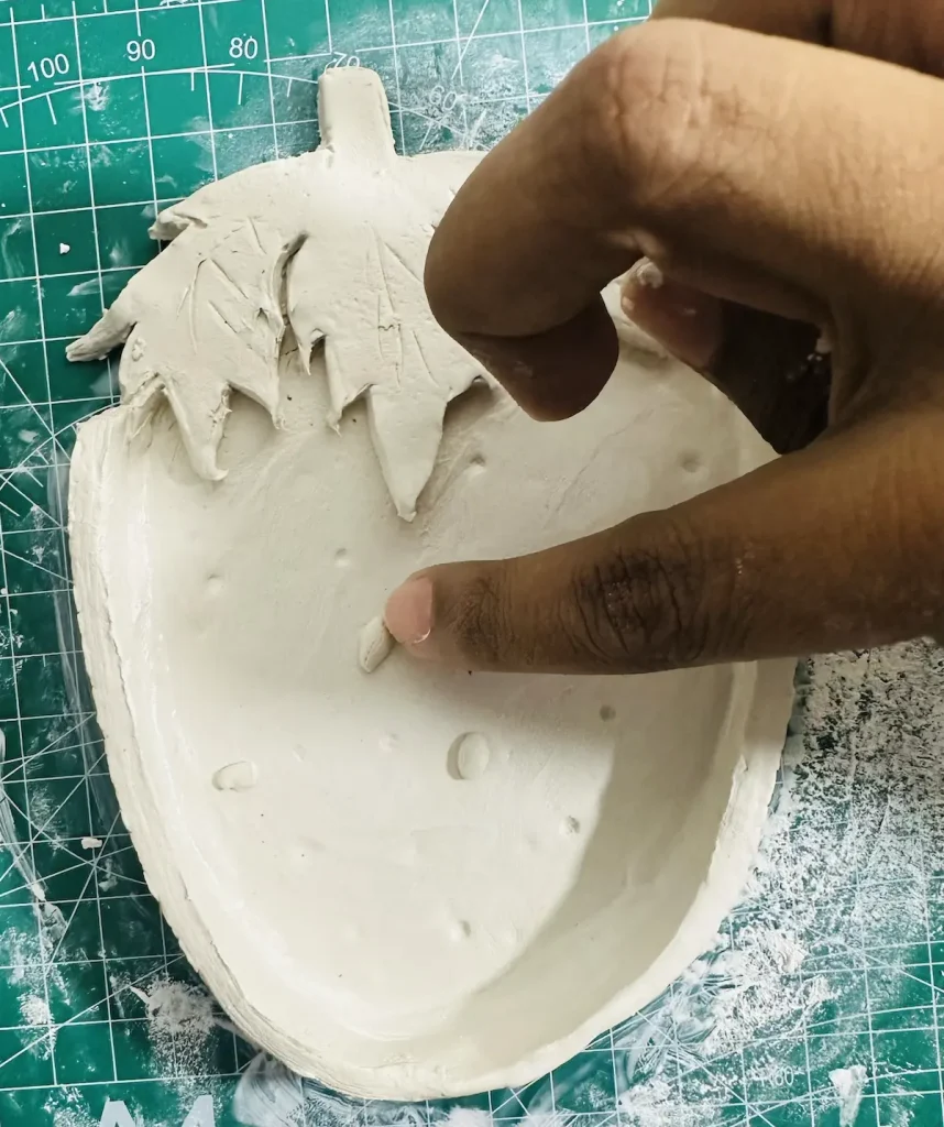 adding strawberry seeds to the tray