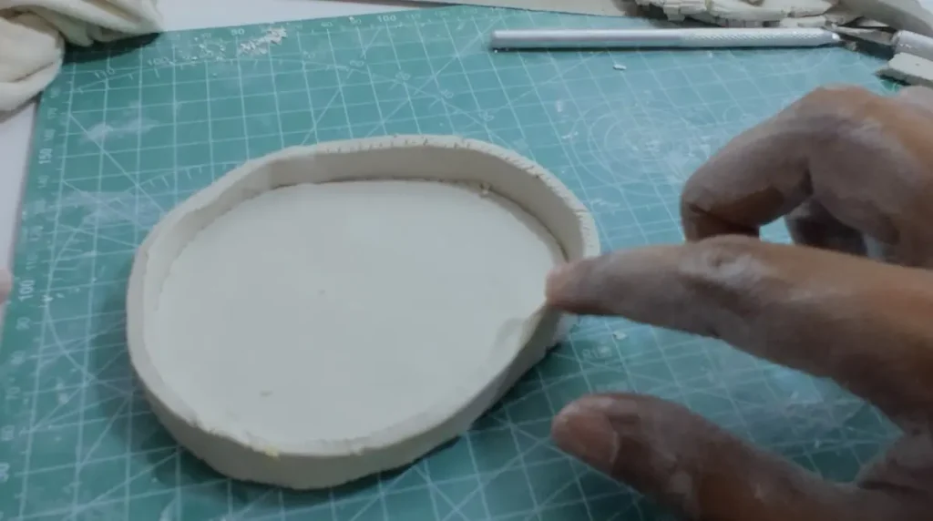 attaching and smoothing the tray rim edges