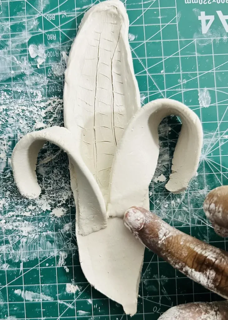 attaching banana peels to the tray base