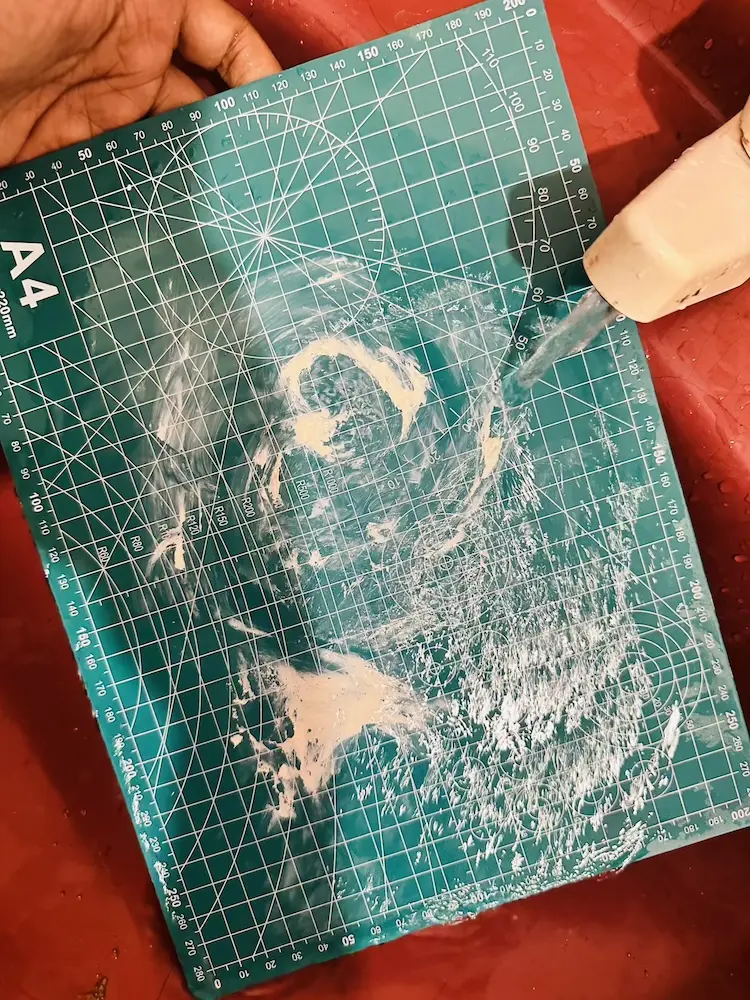 cleaning the PVC mat in the sink
