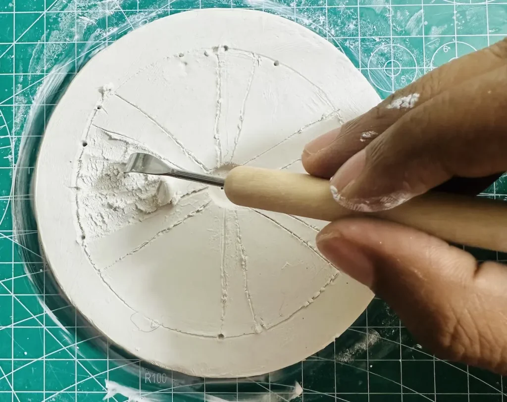 hollowing out the clay using the carving tool
