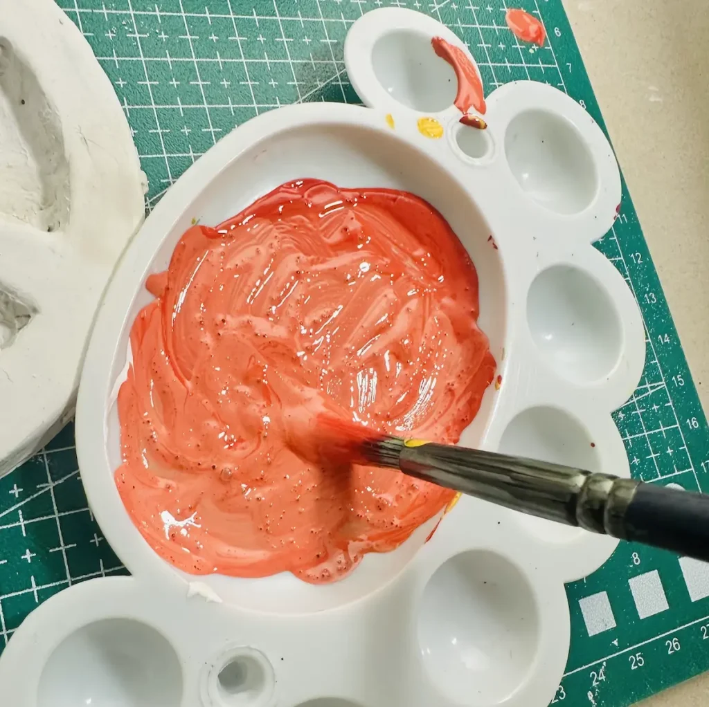 mixing acrylic paint for carved orange dividers