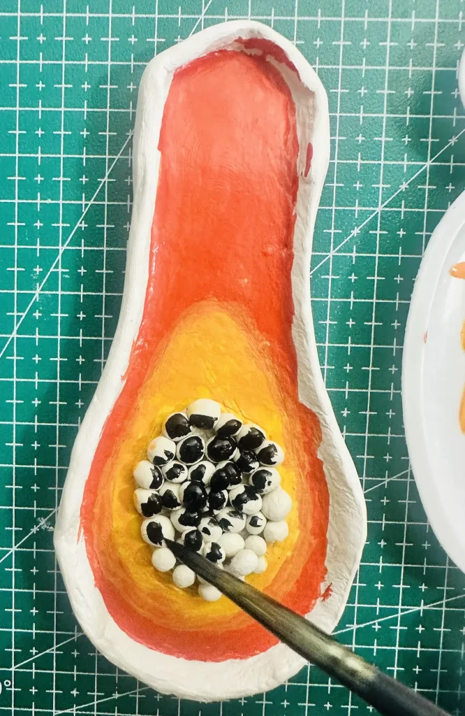 painting the papaya clay seeds