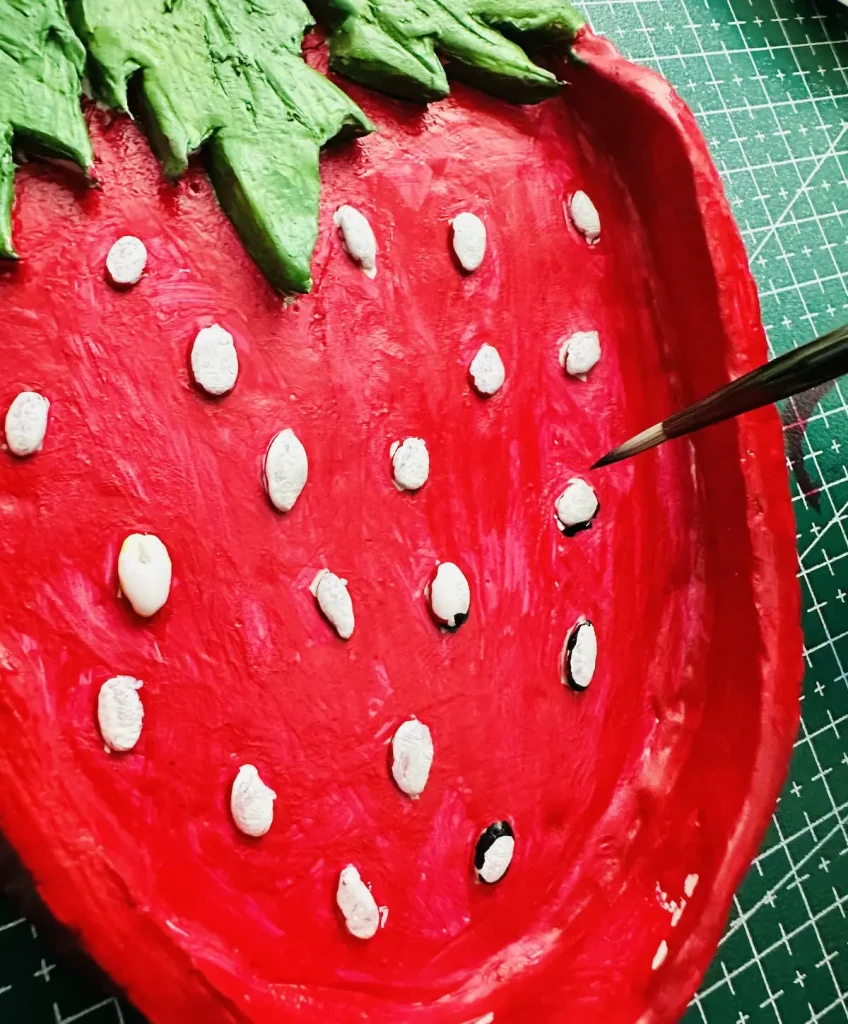 painting the strawberry seeds