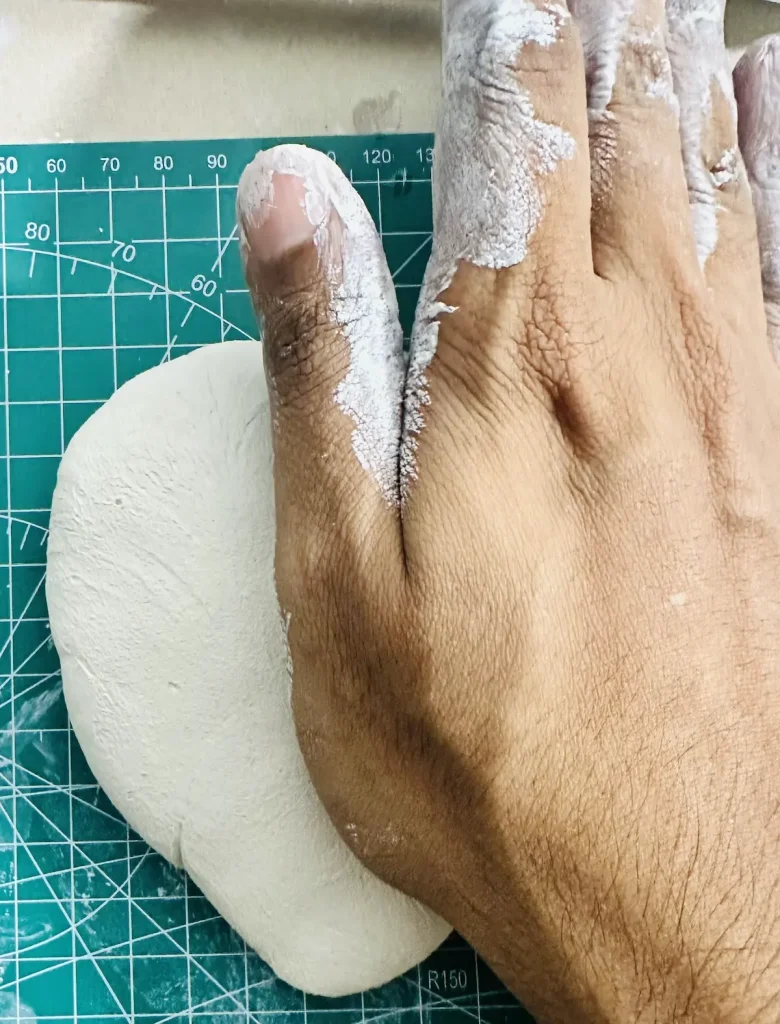 pressing and kneading the clay