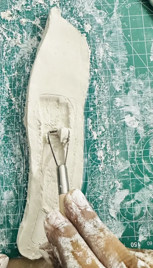 scooping out the clay using ribbon tool