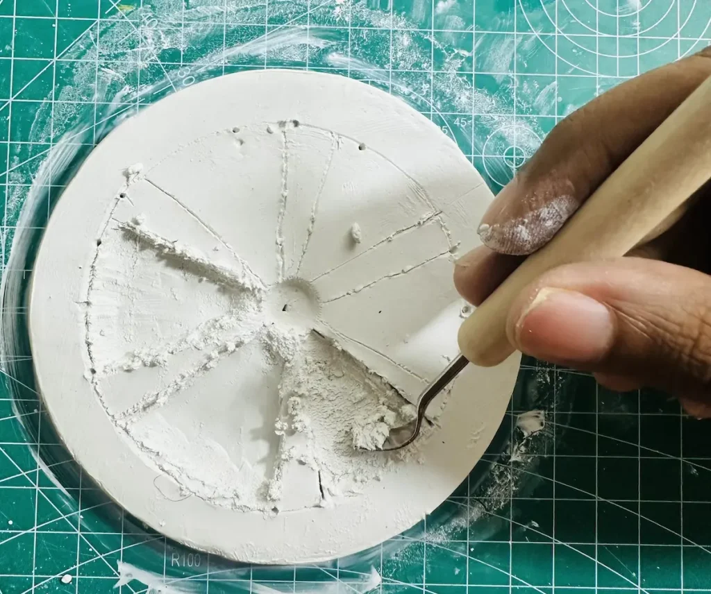 scooping the clay with tool