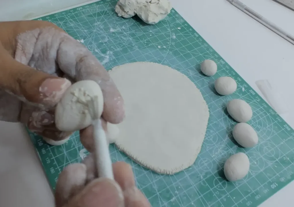 scoring clay rock surface before attach