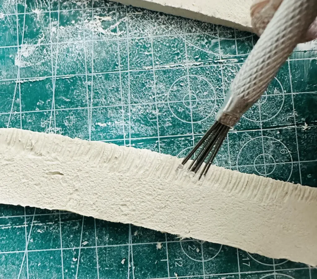 scoring the bottom area of tray rims before attach to tray base