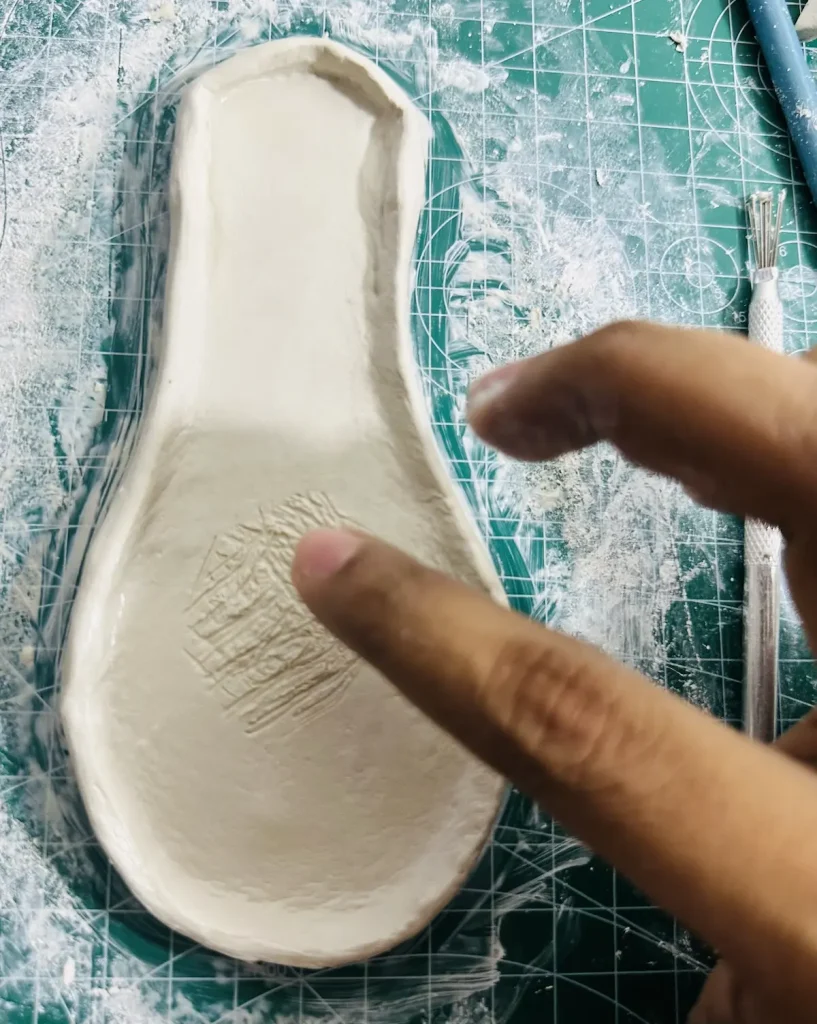 scoring the middle of the base for papaya clay seeds