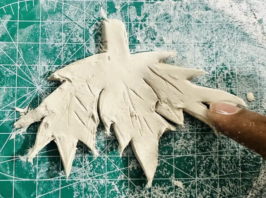 smoothing the clay strawberry leaves