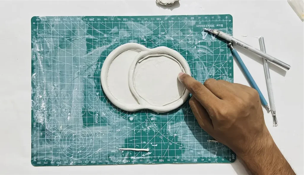 adding the thin clay coil