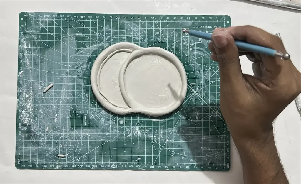 adding the thin clay coil to the second cherry