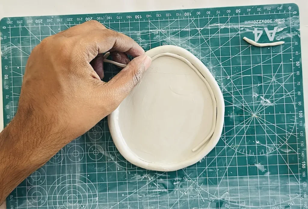adding thin clay coil
