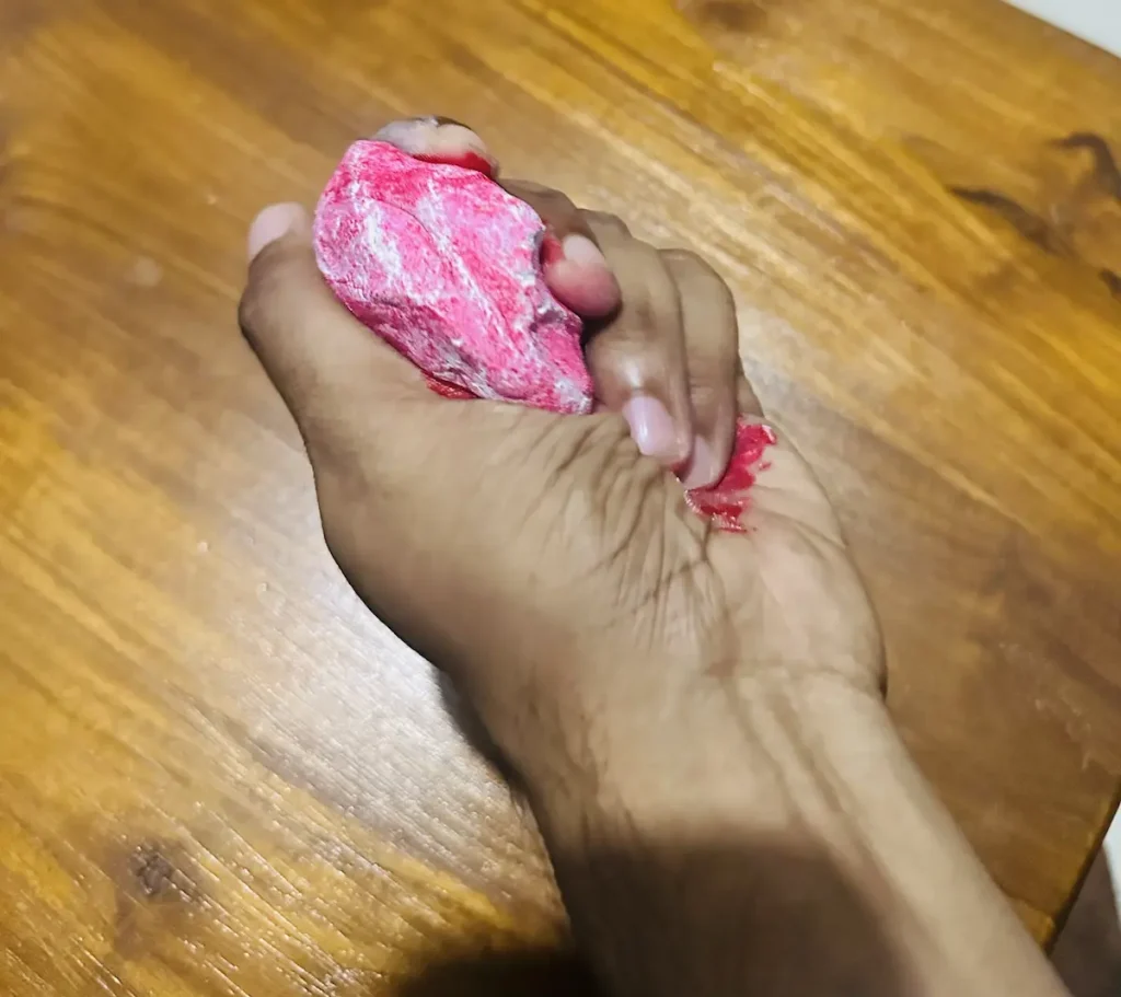 kneading and mixing the paint with wet clay