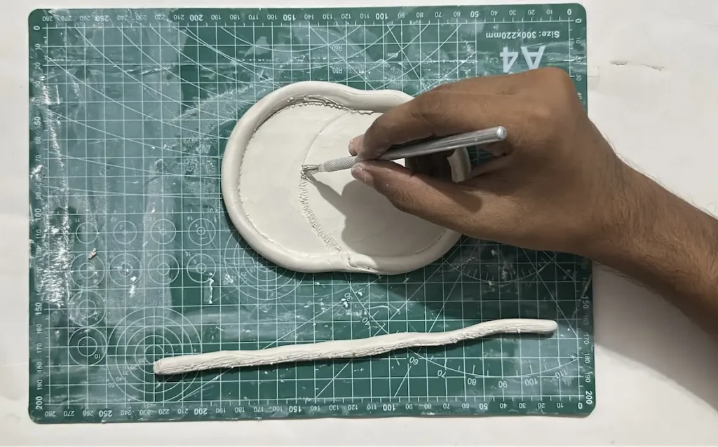scoring the tray base middle to attach middle tray rim