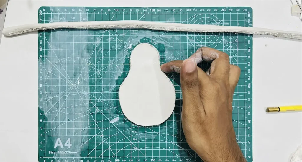 tapping scored areas of tray base with little bit of water