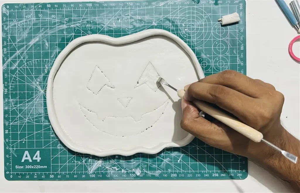 hollowing out the clay to make the eyes