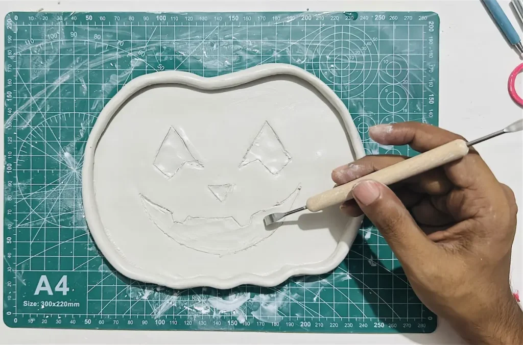 hollowing out the clay to make the mouth