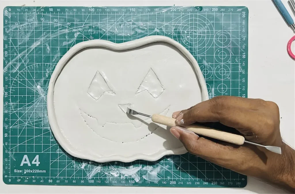 hollowing out the clay to make the nose