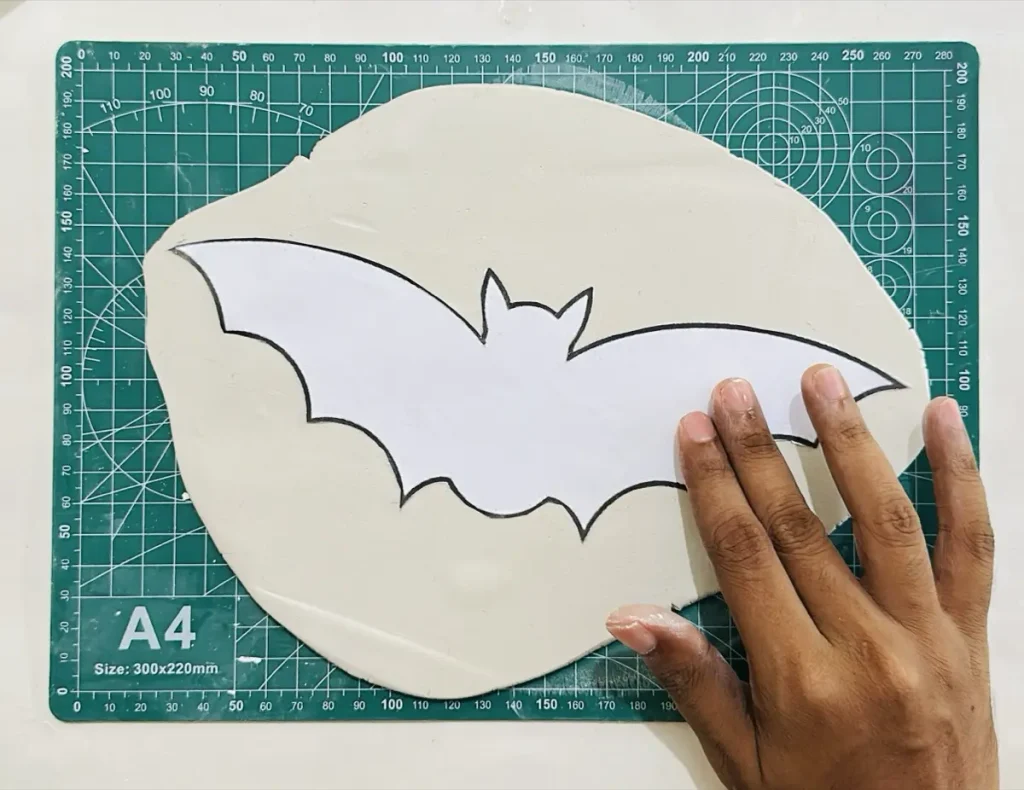 pasting paper template on the clay slab